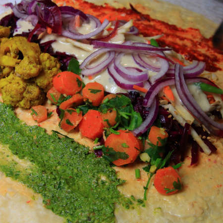 vegetable pancake vegan with sauce, carrot, onion,  parsley and cabbage