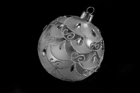 Silver christmas bulb decoration isolated on blackの写真素材