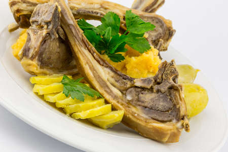 White plate with baked sheep ribs isolated on whiteの写真素材
