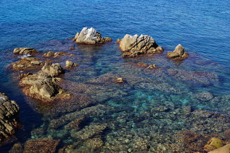 Stones and rocks at the edge of the seaの写真素材