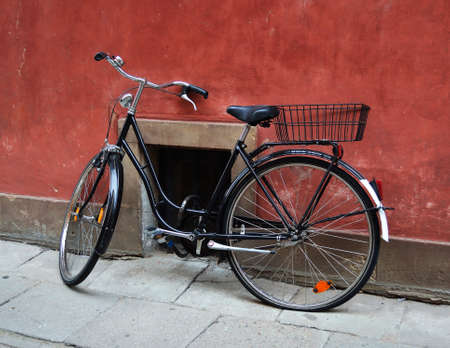 Old bicycle parked in front of a buildingの写真素材