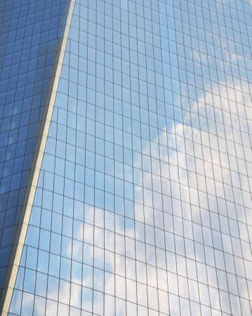 Cloudy sky reflected in the windows of a skyscraperの写真素材