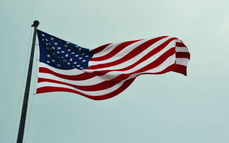 American flag waving in a skyの写真素材