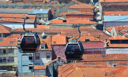 Cable Car Cabins over red roofs of old buildingsの写真素材
