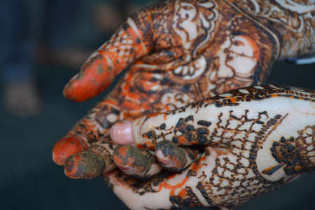 Woman hands with bridal mehndi tattoo