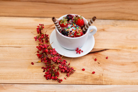 Cup of coffee with ice cream and berries on a wooden backgroundの写真素材