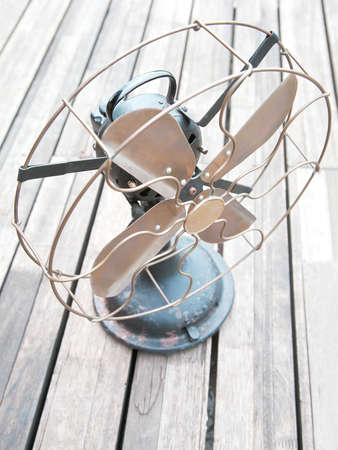 old cooler fan on wood slat deckingの写真素材