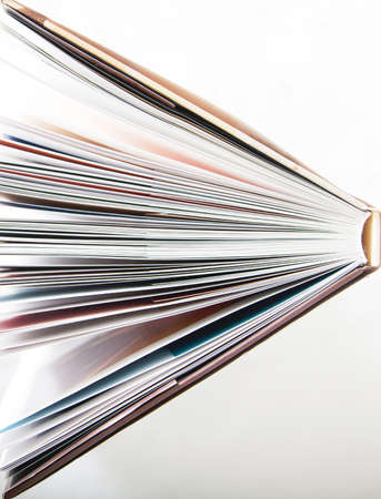 open hard back book on plain background, portrait, copy spaceの写真素材