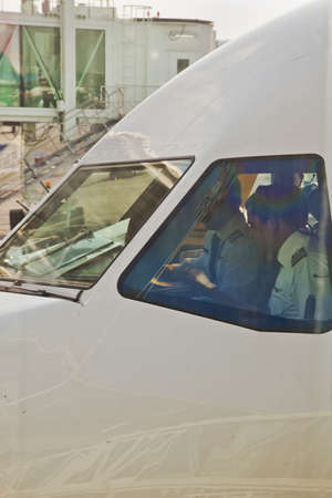 Chennai, India - April 14, 2013  Captian and co-pilot make routine pre-flight checks on a commercial...