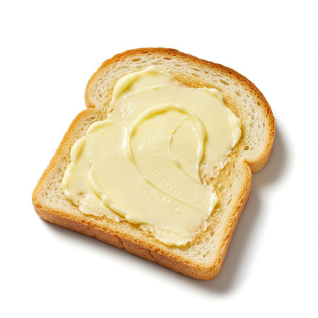 Slice of bread with butter isolated on white background, top viewの素材