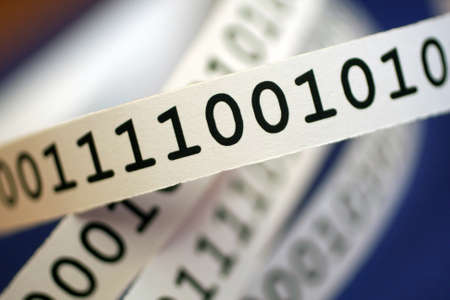 binary code on white ribbonの写真素材