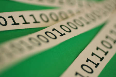 binary code on white ribbonの写真素材