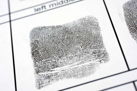 A fingerprint on a white sheet of paperの写真素材