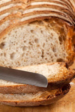 Sliced bread on a wooden board.