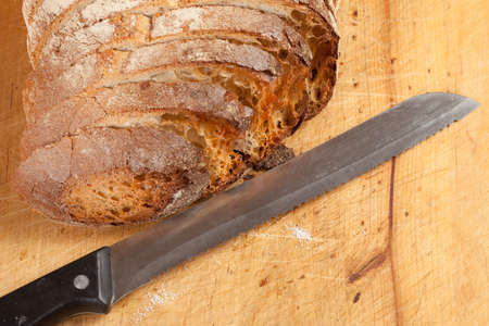 Sliced bread on a wooden board.