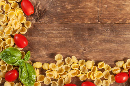 Raw pasta with basil and other ingredients の写真素材