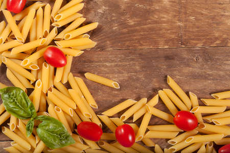 Raw pasta with basil and other ingredients の写真素材