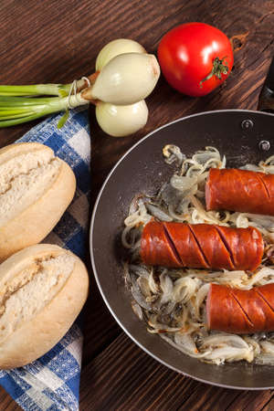 Fried sausage with onions in the pan の写真素材