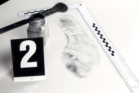 Revealing and preserving the shoe prints- investigation of the scene.の写真素材