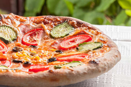 Homemade pizza with vegetables and baconの写真素材