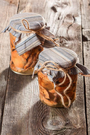 Marinated mushrooms in a glass container.の写真素材