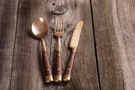 Cutlery on a wooden table.