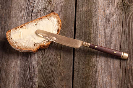 A slice of bread spread with butter.の写真素材