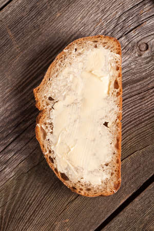A slice of bread spread with butter.
