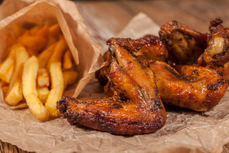Roasted chicken wings and chips.
