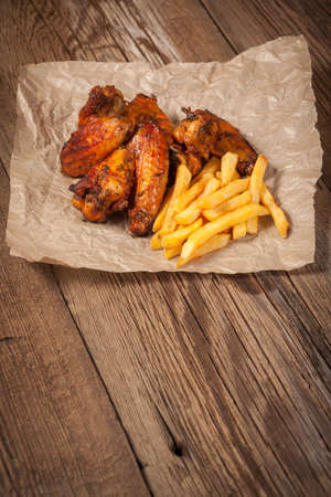 Roasted chicken wings and chips.の写真素材