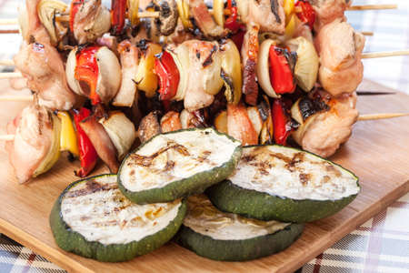 Grilling shashlik on wooden table.の写真素材