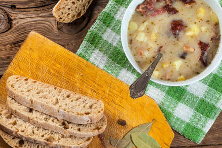 Tasty sour soup in a bowl on a wooden table.の写真素材