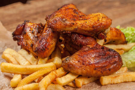 Roasted chicken wings and chips.の写真素材