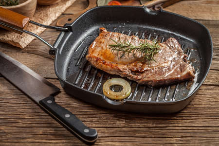 Fried beef steak in a frying pan.の写真素材