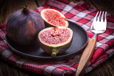 Sliced figs on a wooden table. Shallow depth of field.
