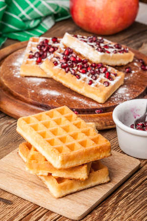 Waffles with pomegranate. on wooden board.の写真素材