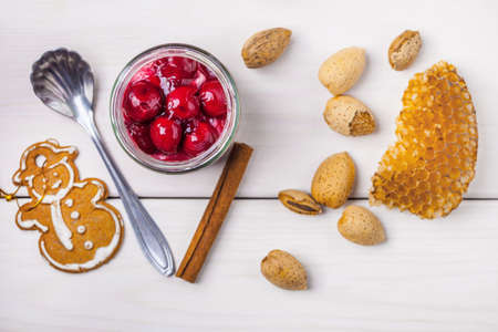 Layered dessert with fruits, nuts and cream cheese in glass jar. Top view.