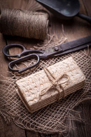 Dry diet crisp breads with ears of wheat on a wooden table. Shallow depth of field.の写真素材