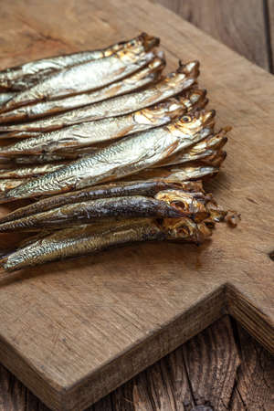 Tasty smoked sprats on a chopping board.の写真素材