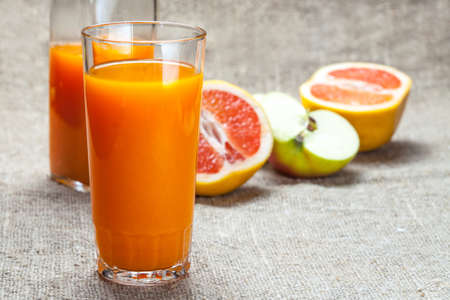 Fresh juice with apples and red grapefruit. Selective focus.の写真素材