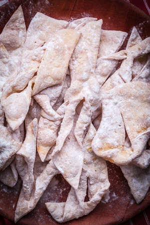 Angel wings sprinkled with powdered sugar on a wooden table. Selective focus.の写真素材