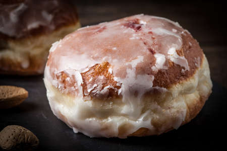 Donut with icing and rose jam. Dark light.の写真素材