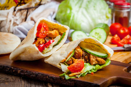 Fried chicken meat with vegetables in pita bread. Selective focus.の写真素材