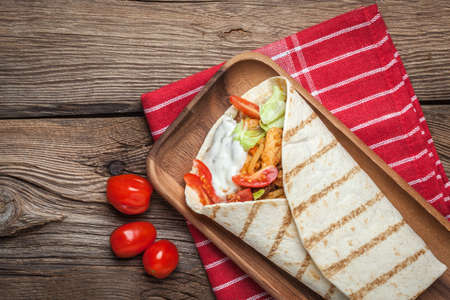 Tasty fresh wrap sandwich with chicken, vegetables and tzatziki sauce.の写真素材