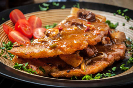 Potato pancakes with meat, vegetable, tomato and parsley. Selective focus.の写真素材
