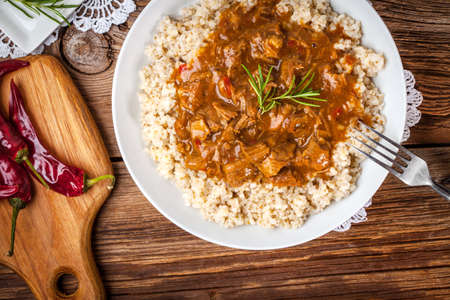 Tasty meal - cooked barley porridge and stew of pork.の写真素材