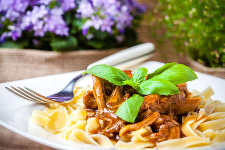 Tagliatelle with dark sauce. Italian cuisine.の写真素材