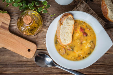 Pea soup with bacon and sausage in a bowl. Top view.の写真素材
