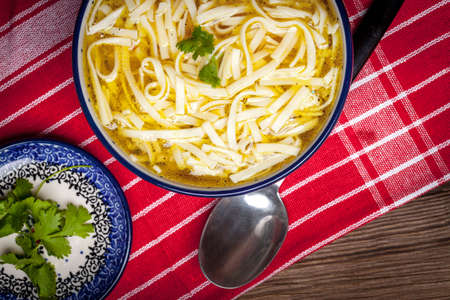 Chicken noodle soup on wooden table. Top view.の写真素材