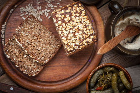 Whole Grain rye bread with seeds on a wooden board.